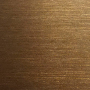 Close-up of a brushed brass surface, showing a textured finish with horizontal lines and a warm golden colour.