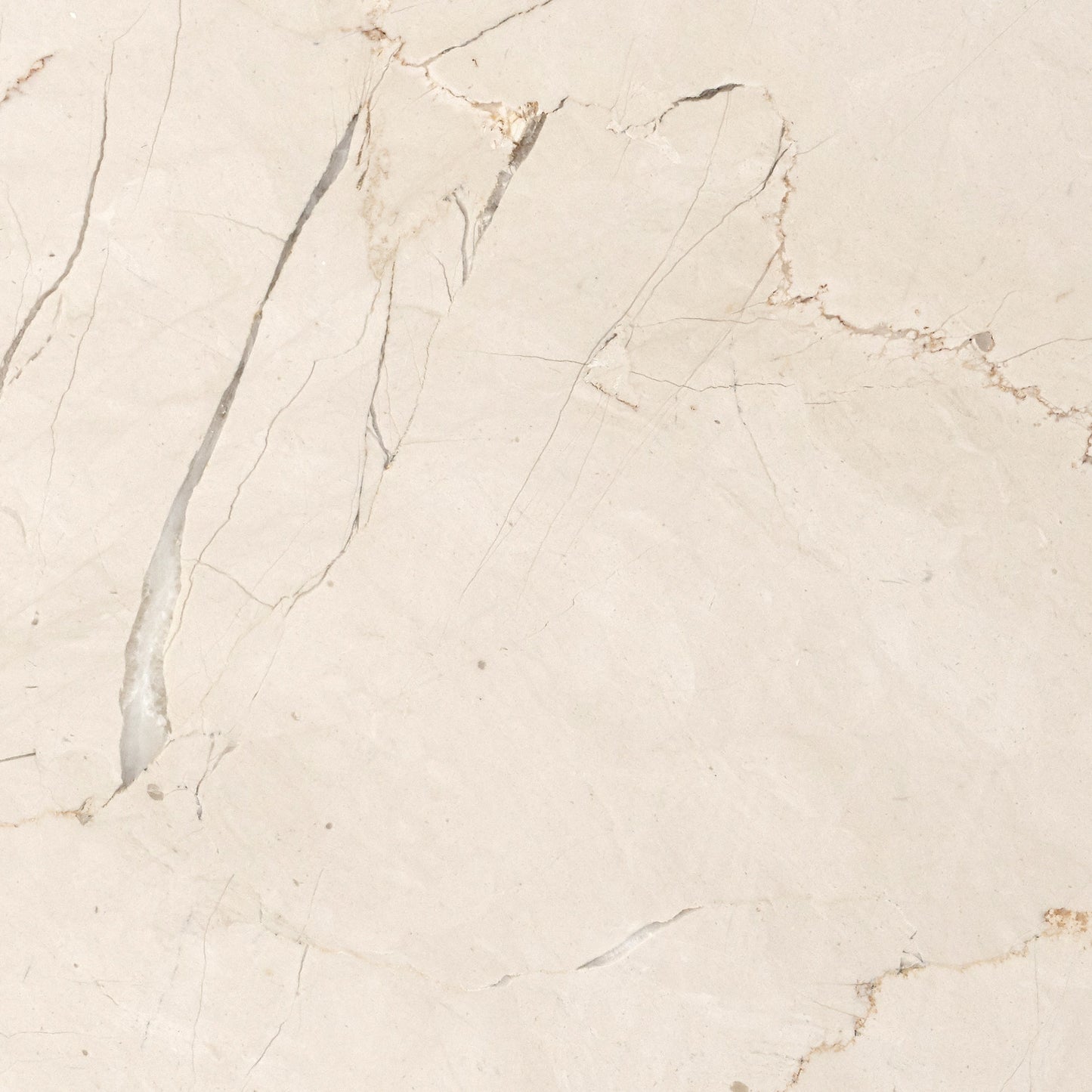 Close-up image of Crystal Rose Marble, featuring a creamy beige surface with intricate grey and brownish-red veins.