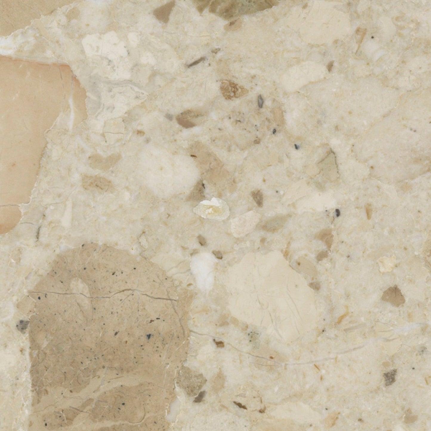 Close-up swatch of Kunis Breccia stone. The polished surface is a composite of beige, tan, and cream-coloured fragments.