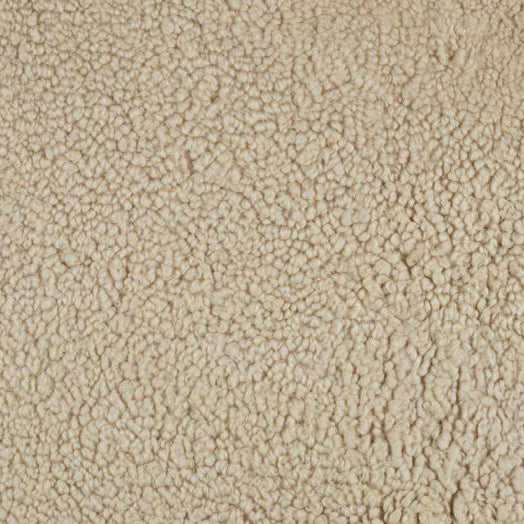 A close-up texture shot of a soft, light beige shearling or bouclé fabric, showing its dense, bumpy, and curly pile.