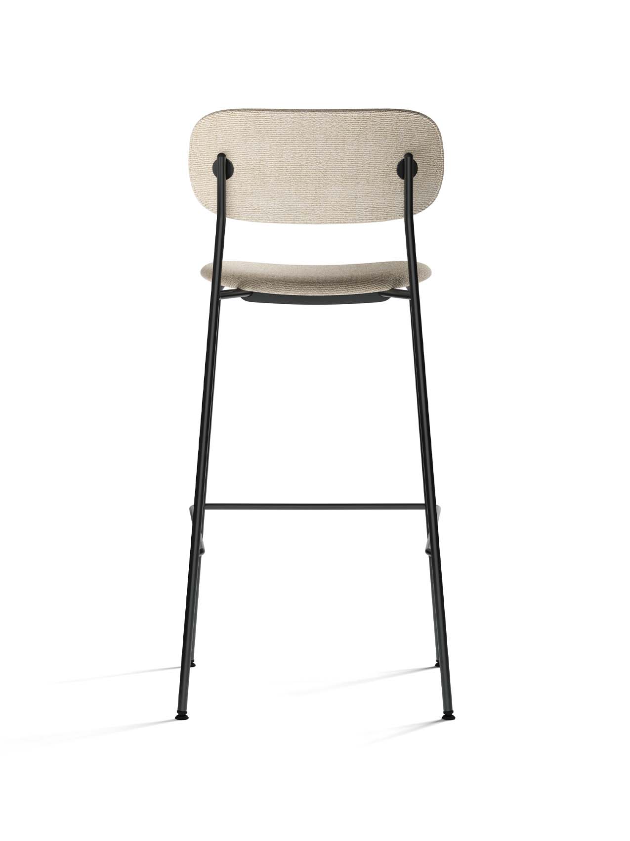 Rear view of the Co Bar Chair, Fully Upholstered, with light beige fabric seat and back on a slender black steel frame.