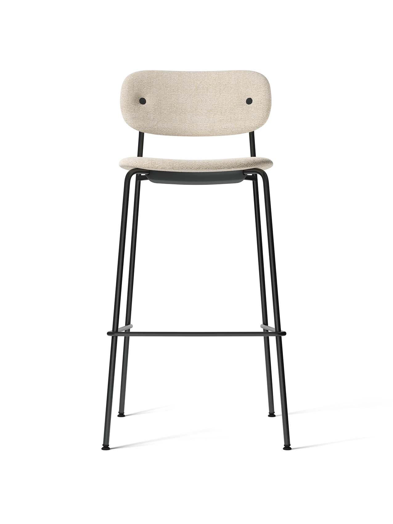 Front view of the Co Bar Chair with a black steel frame, footrest, and light Moss fabric upholstery on its seat and back.