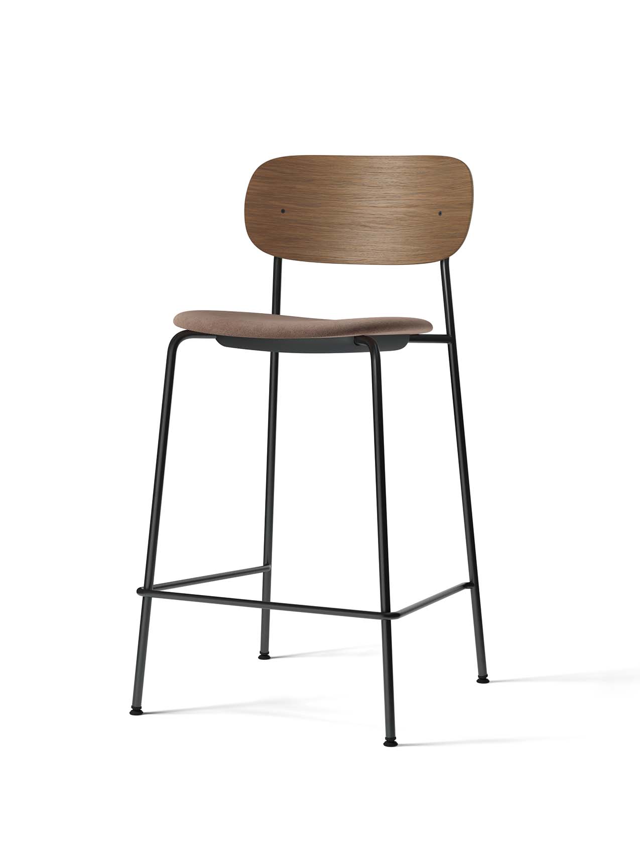 A Co Counter Chair with a black steel frame, a brown upholstered seat, and a contoured backrest in dark stained oak.