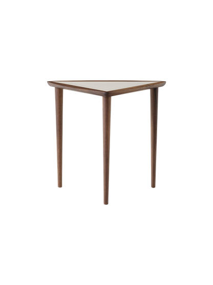 The Umanoff Nesting Side Table in Walnut and Fog, seen from the front. It has a triangular top and three slender walnut legs.