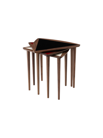 Stacked Umanoff Nesting Side Tables with walnut frames and triangular tops in black, burgundy, and fog.