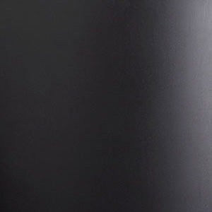 A close-up of a matte black material, showing its smooth texture and surface with a slight sheen from a light source.