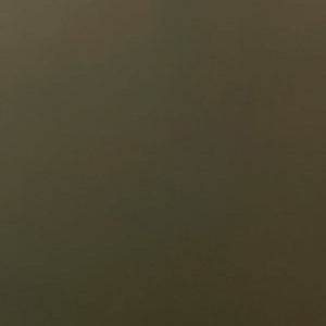 A close-up swatch of dark green glass, displaying a solid, deep green colour with a smooth, slightly matte finish.