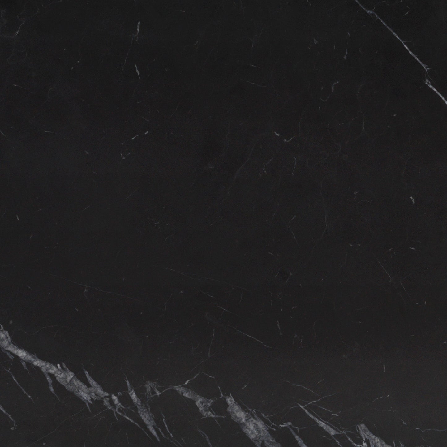 A close-up view of a Nero Marquina marble slab, showcasing its deep black colour with distinctive white and grey veining.