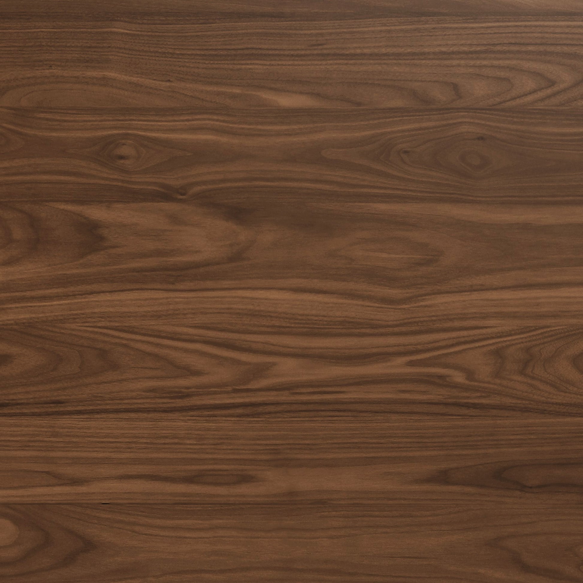 A close-up of a natural walnut wood veneer surface, with a warm, medium-brown colour and distinct horizontal grain.