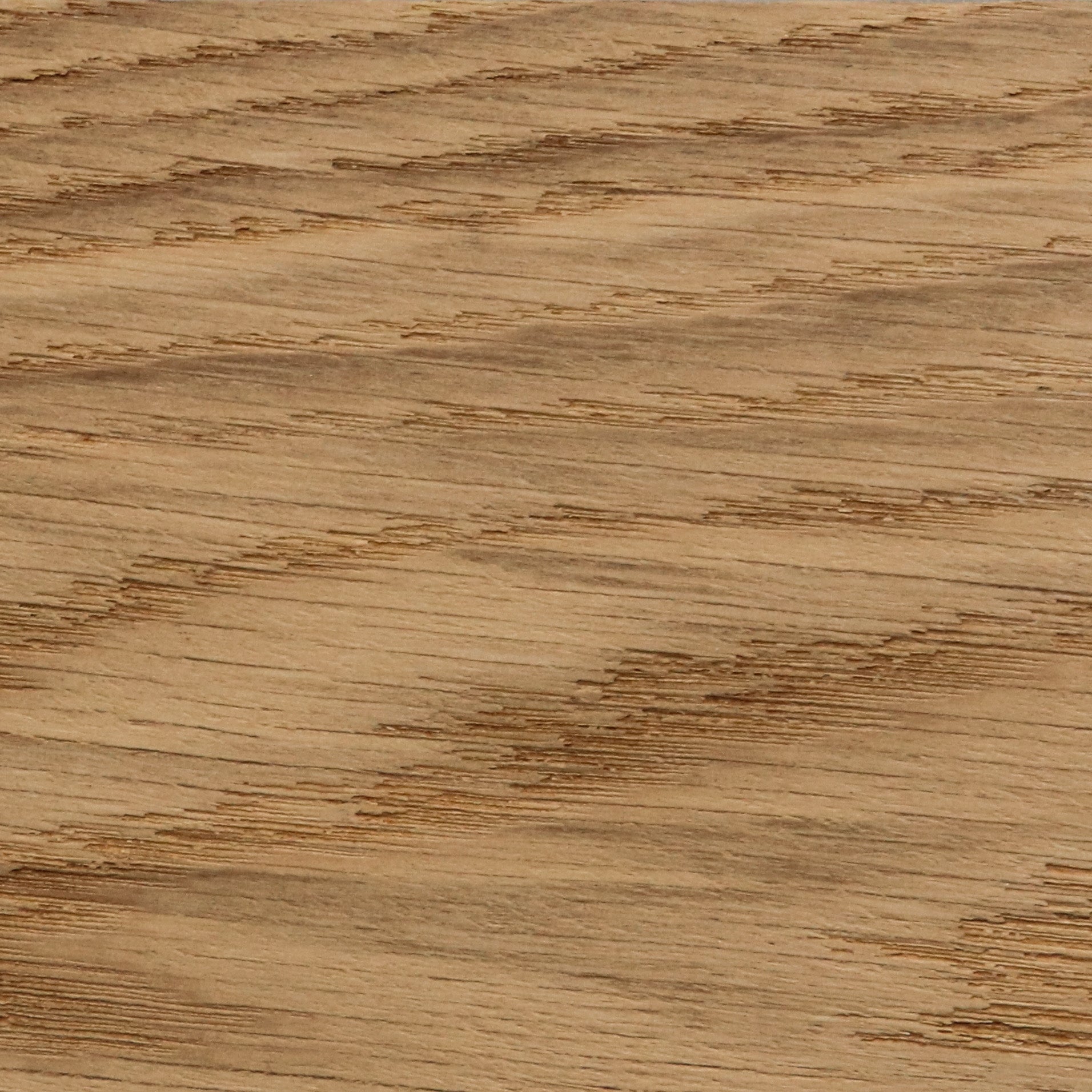 A detailed close-up of a golden oak wood finish, showing the distinct texture and diagonal lines of the natural wood grain.