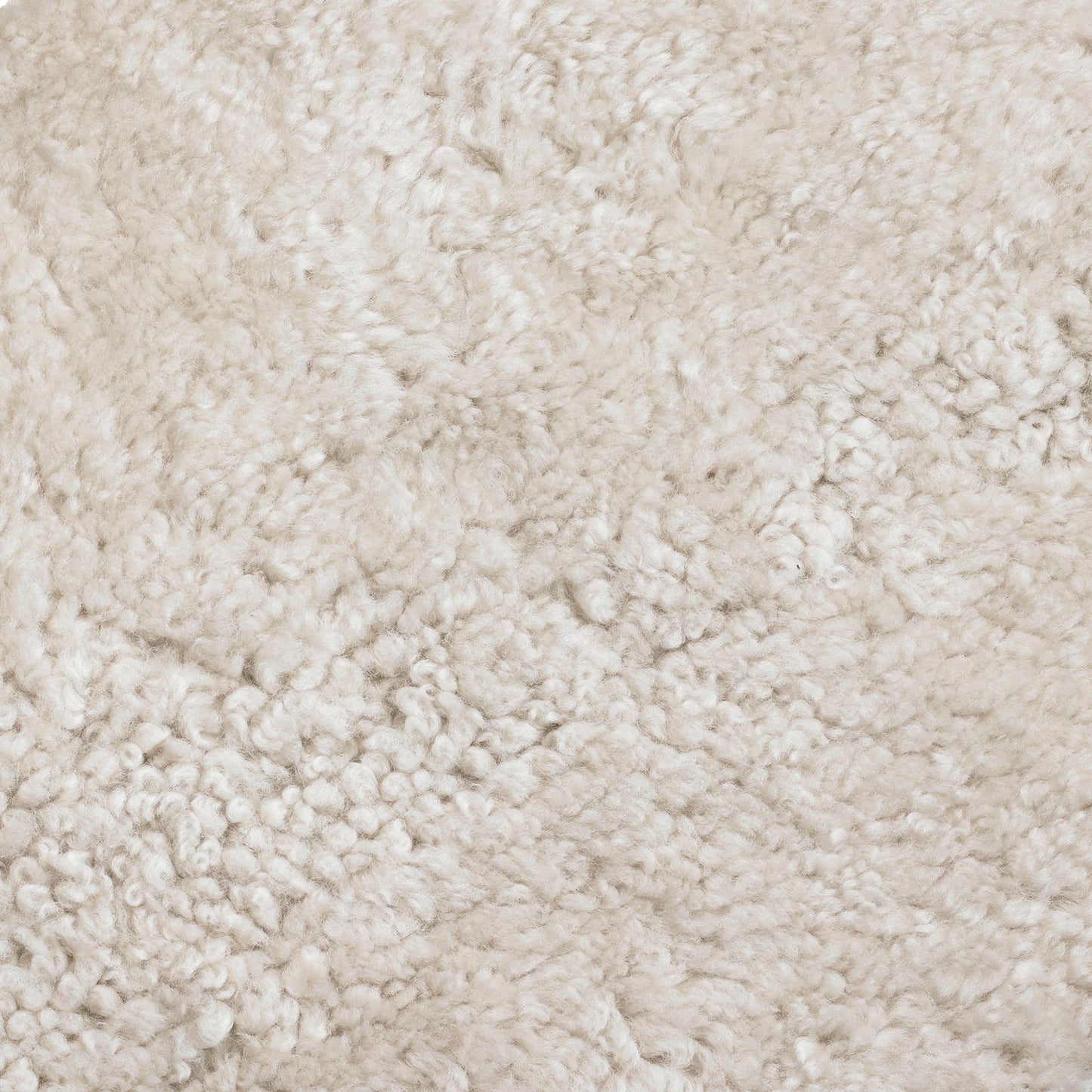 Close-up image of Skandilock Sheepskin in Moonlight, showcasing the material's dense, curly, and soft off-white texture.