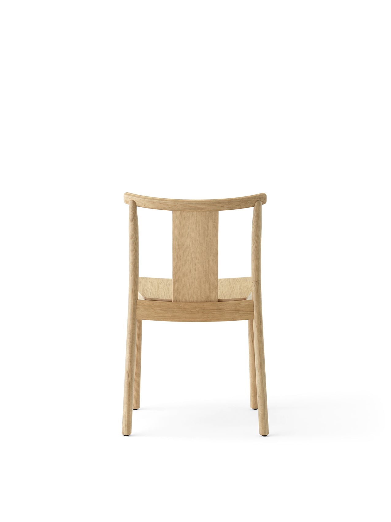 Back view of the Merkur Dining Chair in natural oak, showing its simple wooden frame, curved top rail, and central back slat.