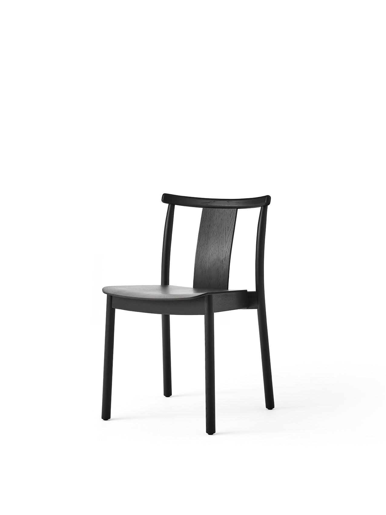An angled view of the Merkur Dining Chair in black oak, shown against a white background. The chair has a minimalist design.