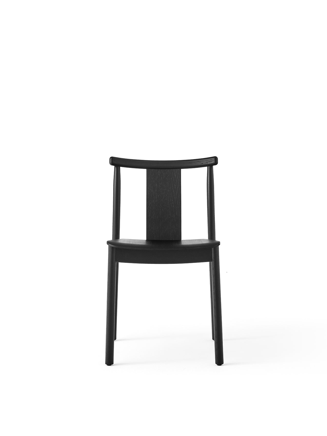 Front view of the Merkur Dining Chair in black oak. The wooden chair has a curved backrest with a central vertical slat.