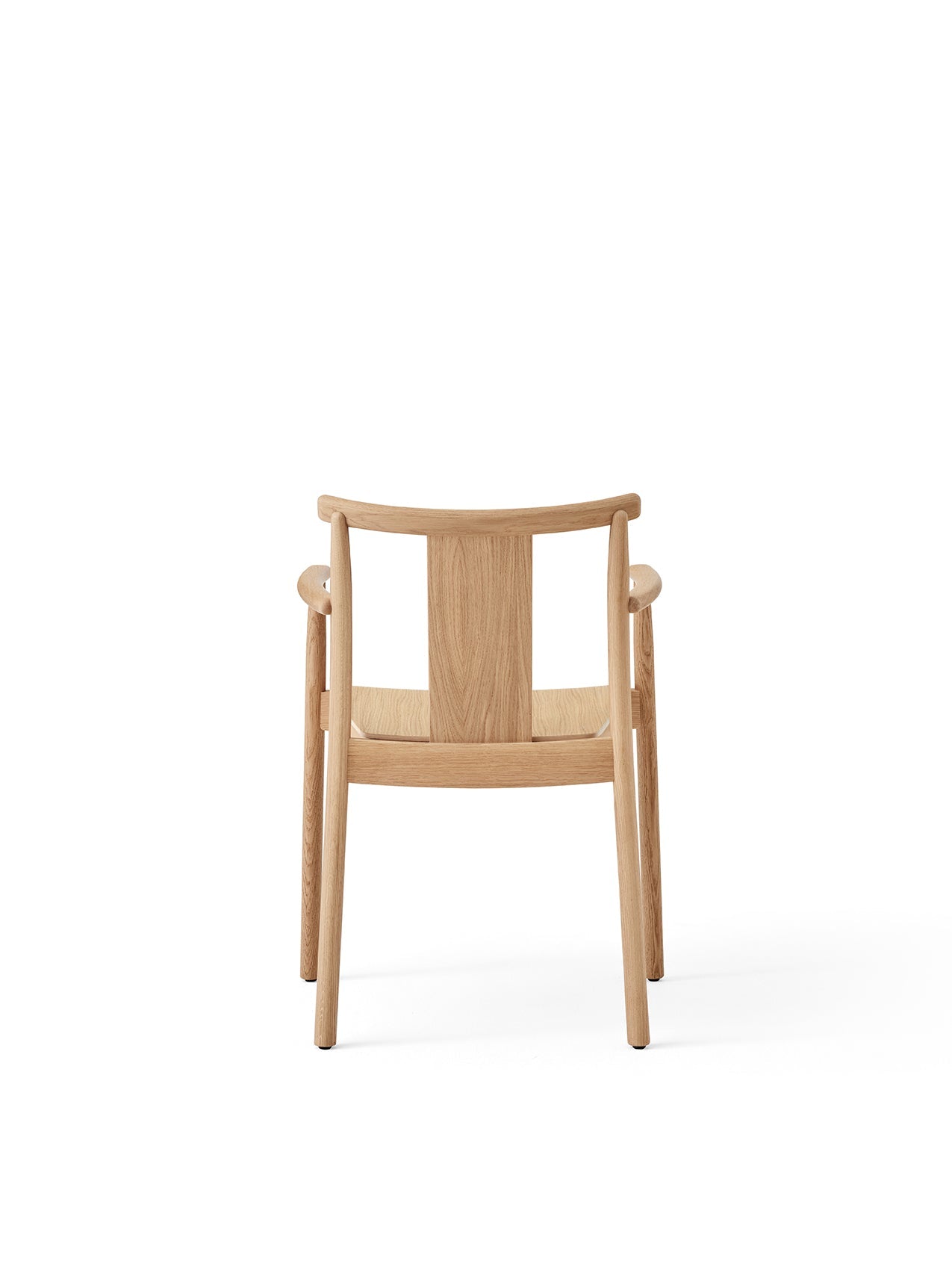 Back view of the Merkur Dining Chair with Armrests in natural oak, showing the curved backrest, arms, and slender legs.