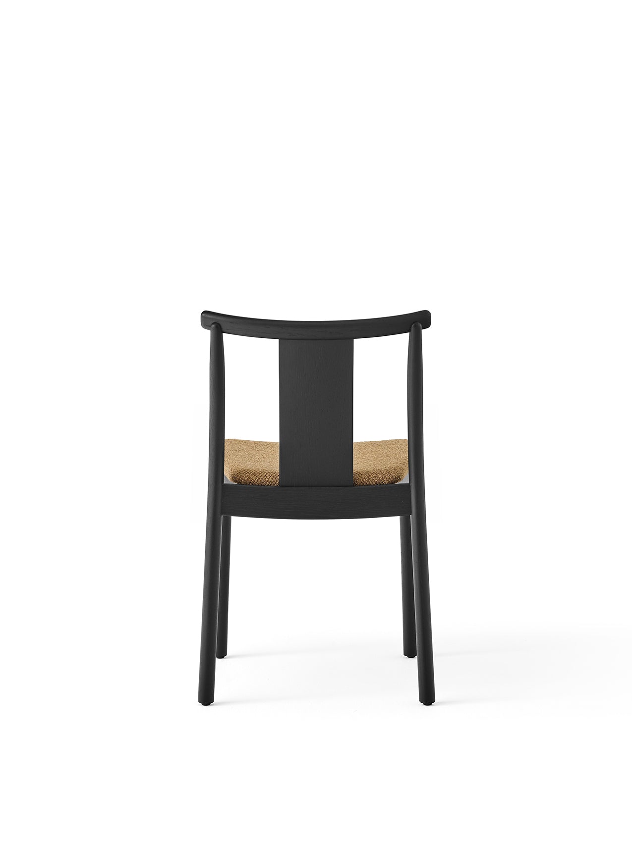 Rear view of the Merkur Dining Chair in black oak with a textured Audo Bouclé 06 upholstered seat against a white background.