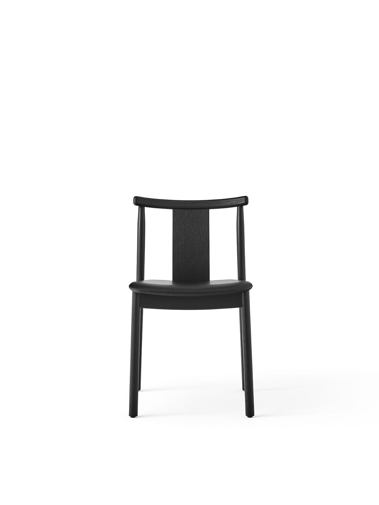 Front view of the Merkur Dining Chair in black oak, featuring a solid seat and a curved backrest, on a white background.