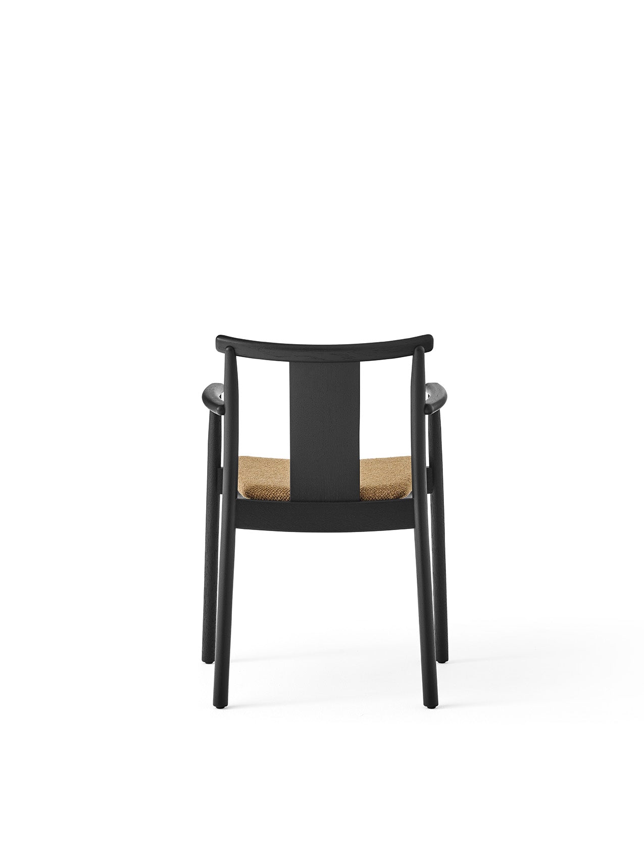 Back view of the Merkur Dining Chair with Armrests, featuring a black oak frame and a seat upholstered in Audo Bouclé 06.