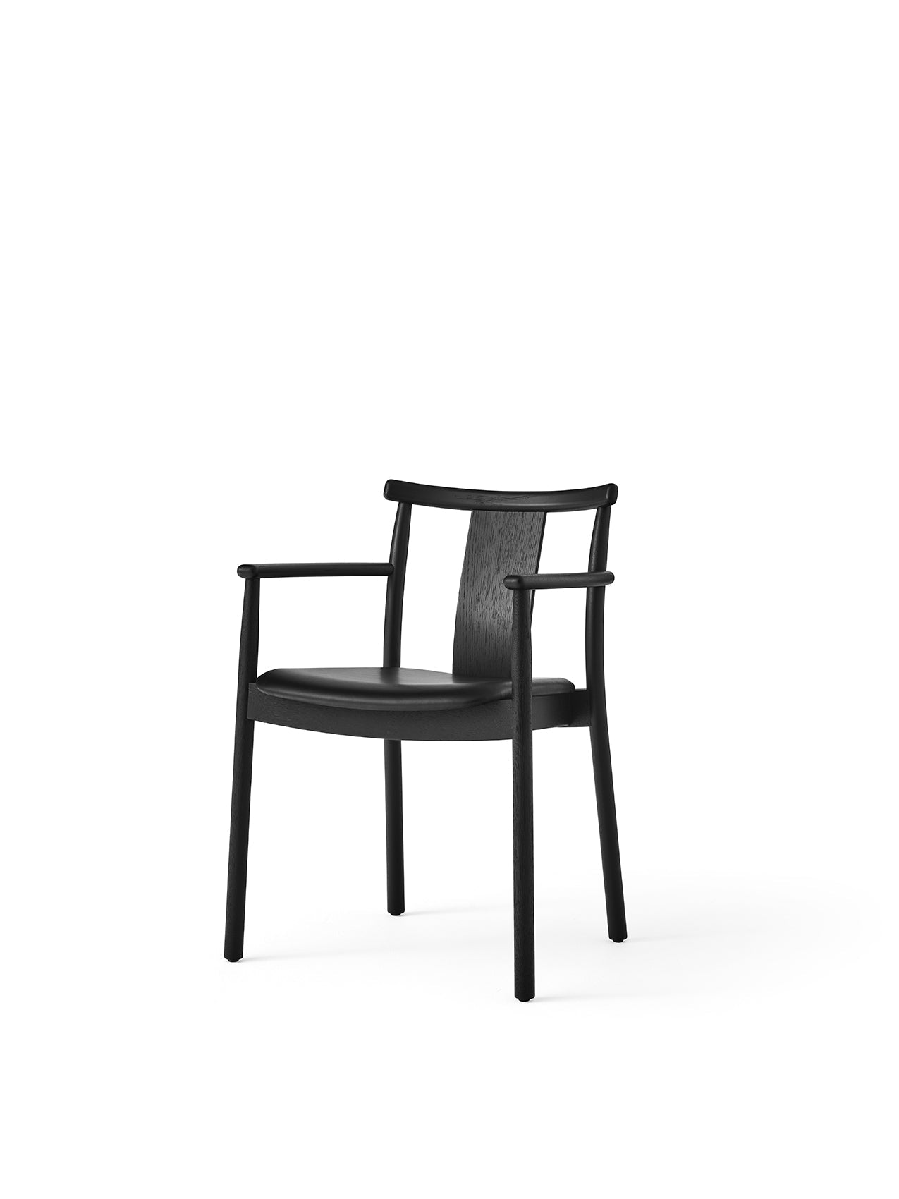 Angled shot of the Merkur Dining Chair with Armrests in black oak with a black leather seat against a white background.