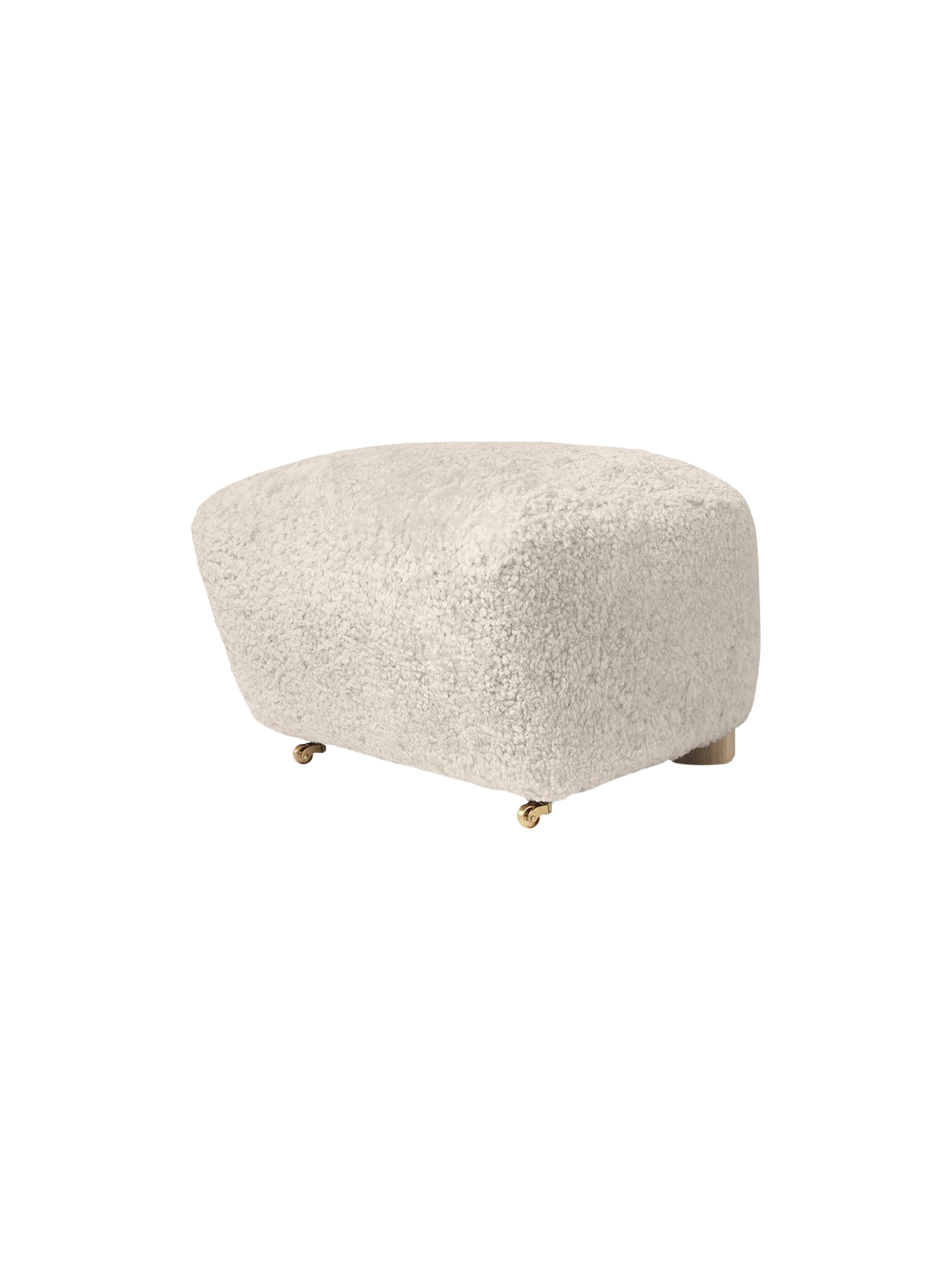 The Tired Man Ottoman in soft, off-white Moonlight sheepskin. The plush footstool features oak legs with brass castors.