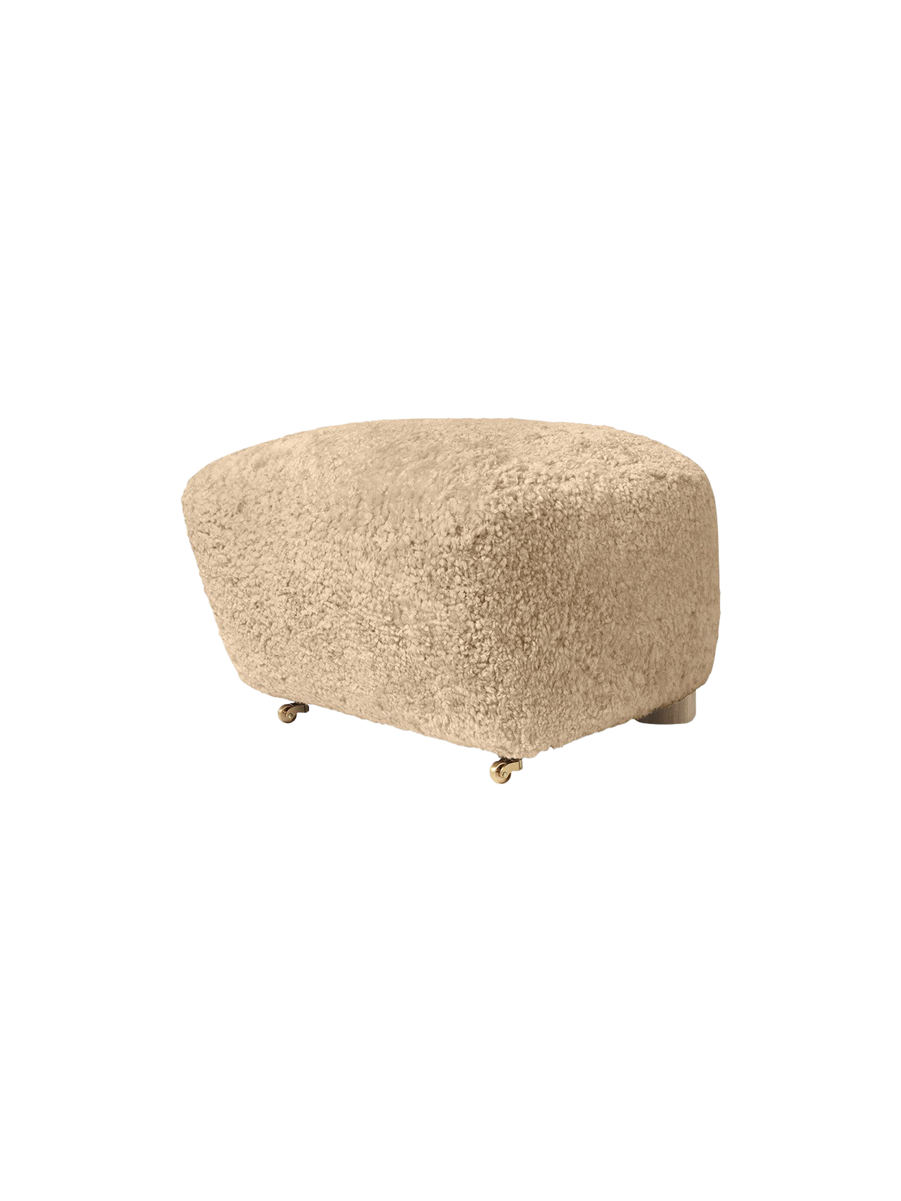 The Tired Man Ottoman upholstered in plush honey sheepskin. A rounded footstool with small brass castors on the front.