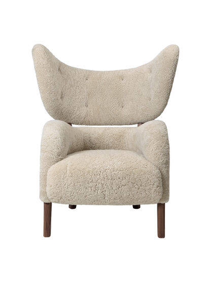 Front view of the My Own Chair upholstered in off-white Sheepskin Moonlight, with a high winged back and dark walnut legs.