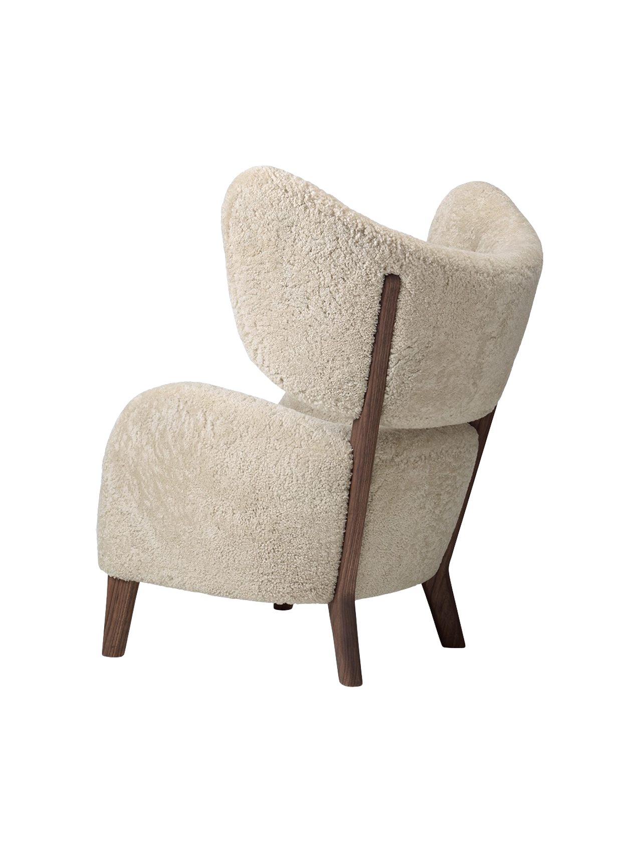 Rear side view of the My Own Chair with plush sheepskin upholstery and a contrasting dark walnut frame.
