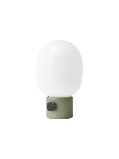 Angled view of the JWDA Table Lamp, Small, featuring an ammonite grey base with a brass dimmer and a white opal glass shade.