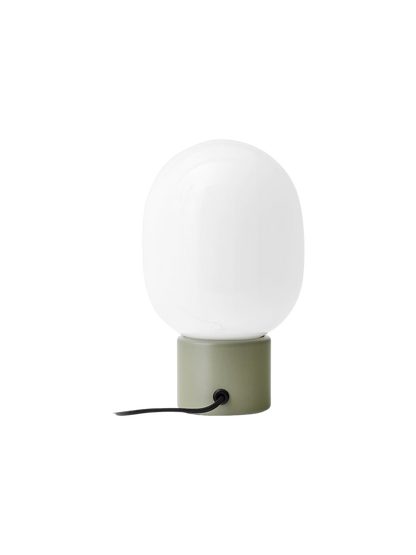 Rear view of the JWDA Table Lamp, Small in Ammonite Grey, with a white opal glass shade and black cord.