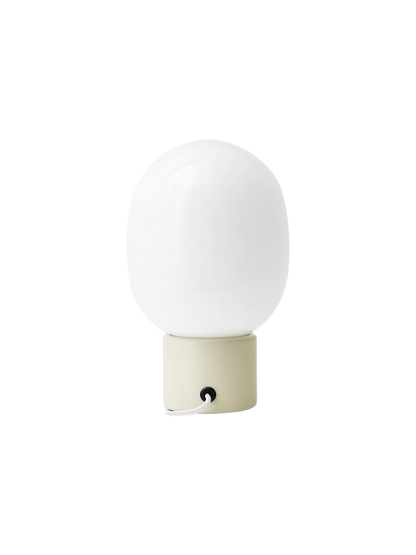 Back view of the JWDA Table Lamp, Small, with an alabaster white steel base and a white opal glass shade.