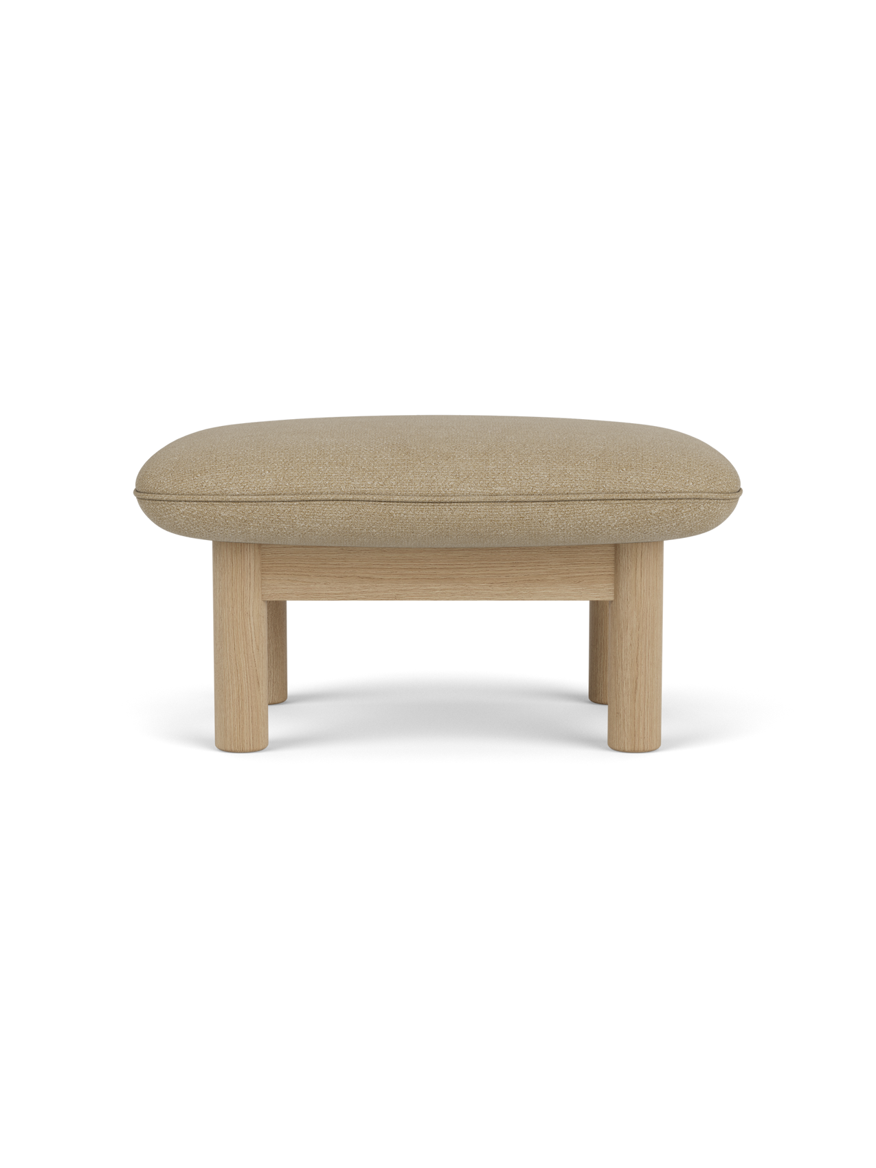 Side view of the Brasilia Ottoman with a light beige Audo Bouclé 02 cushion on a natural oak frame with thick, round legs.