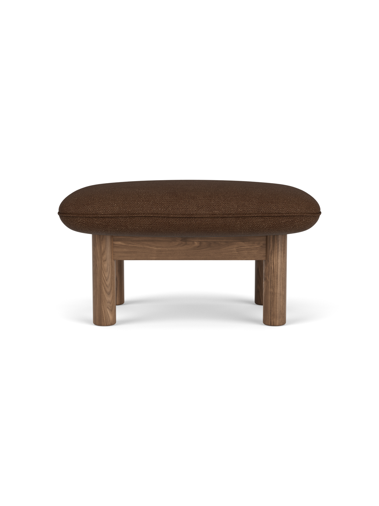 A side view of the Brasilia Ottoman with a walnut frame, four thick cylindrical legs and a plush cushion in brown bouclé.