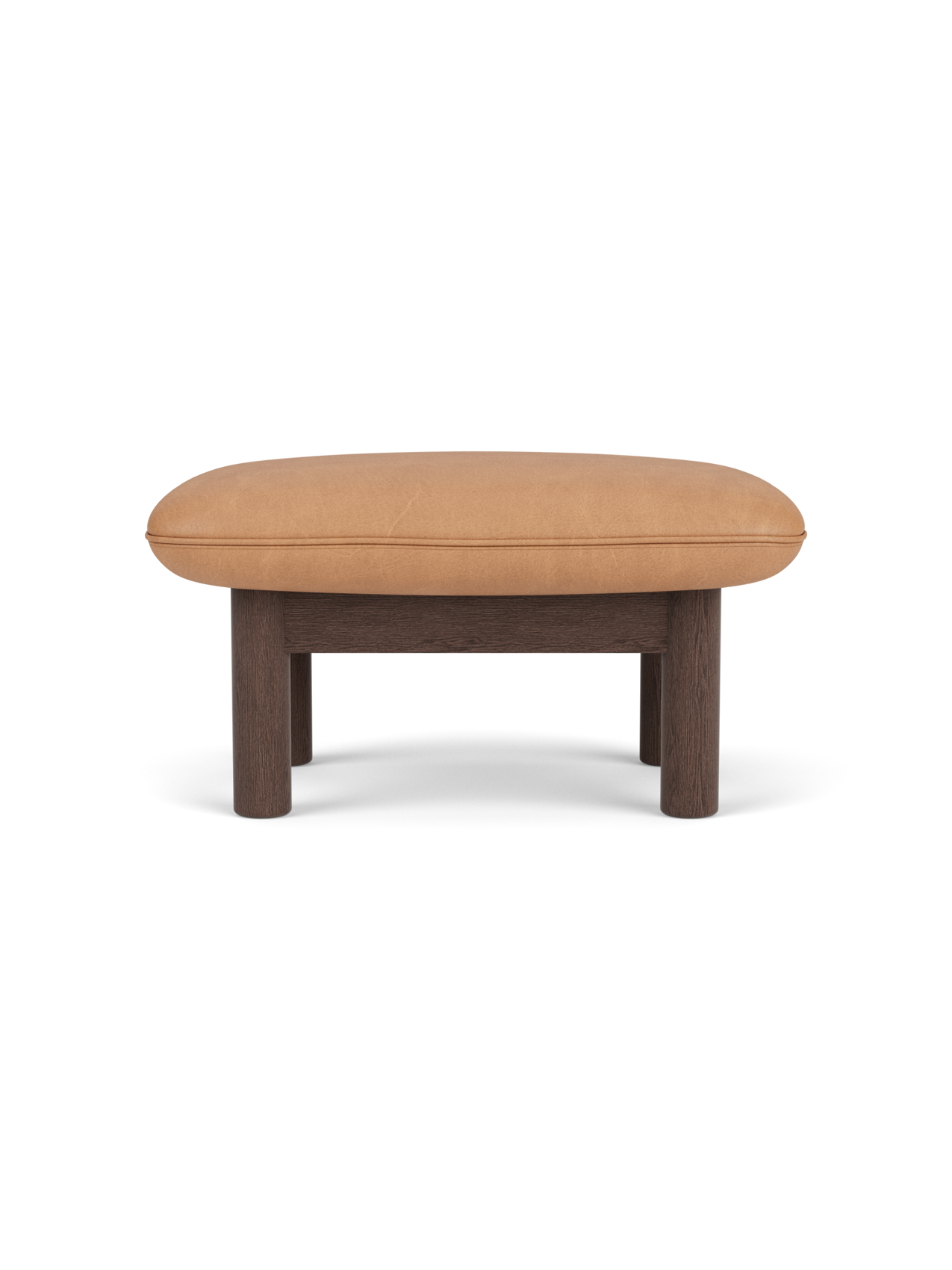 A side view of the Brasilia Ottoman, with a dark stained oak frame, four cylindrical legs, and plush camel leather seat.