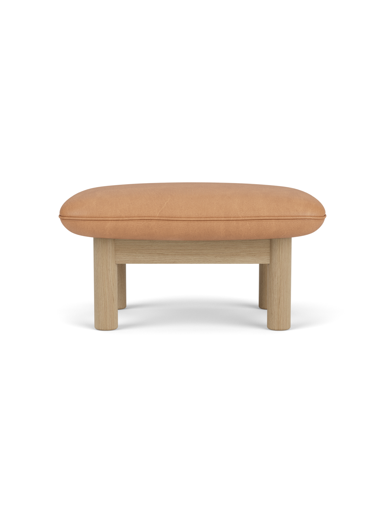 Side view of the Brasilia Ottoman with a camel leather cushion and a natural oak frame with four robust, cylindrical legs.