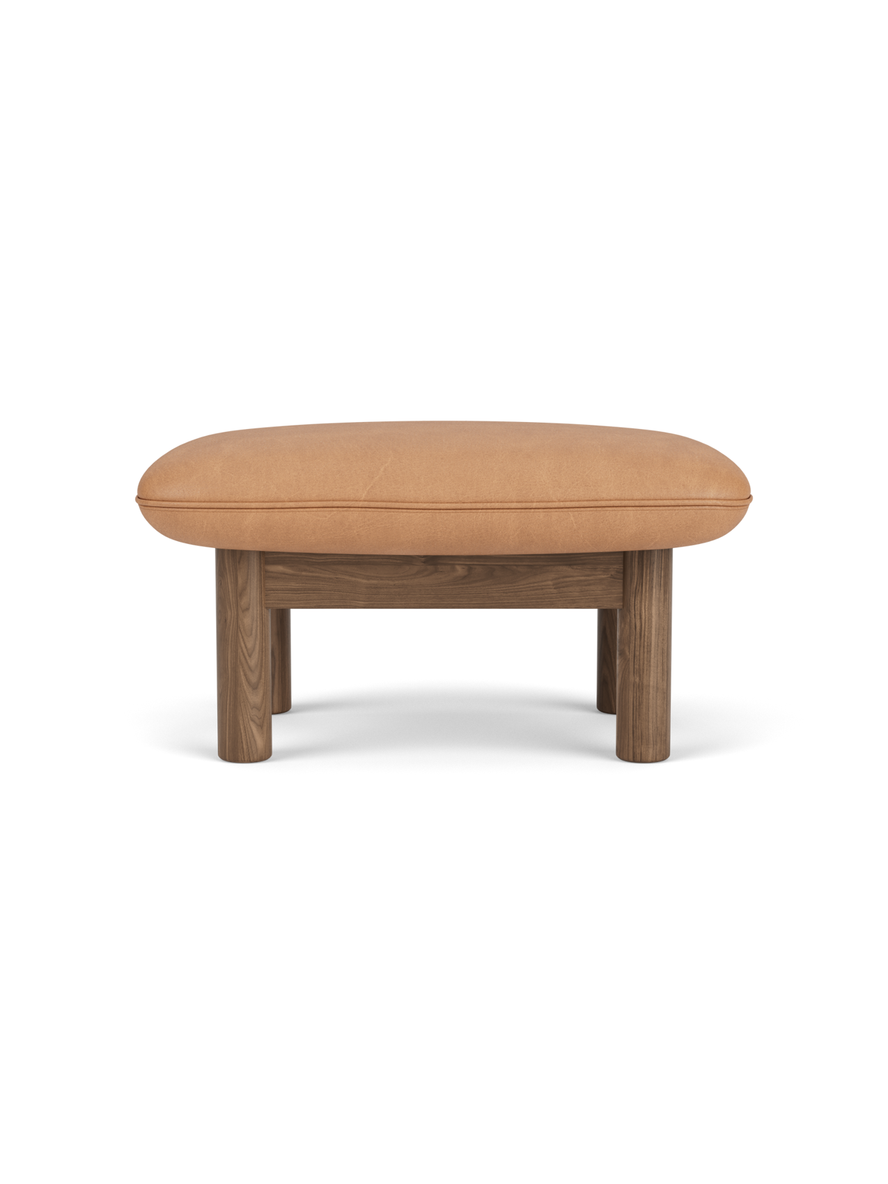 Brasilia Ottoman with a solid walnut frame, four thick cylindrical legs, and a soft, rounded camel leather cushion.