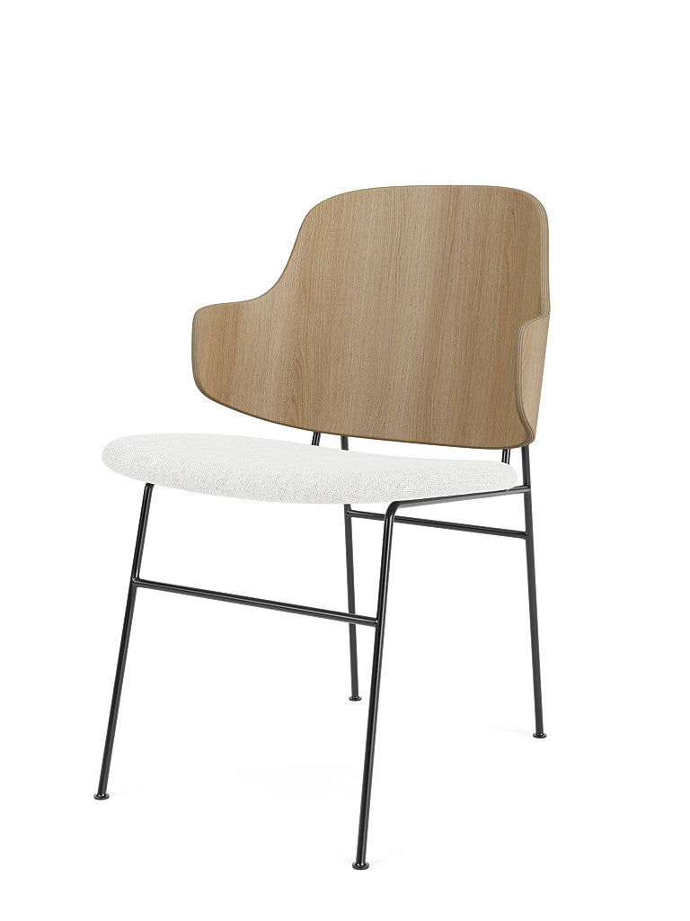 The Penguin Dining Chair, viewed from an angle, with a natural oak back, white textured seat, and thin black metal frame.