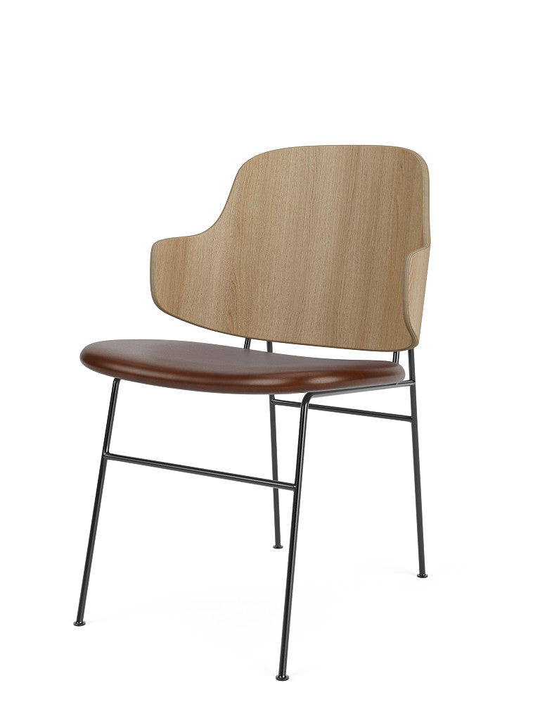 Angled view of The Penguin Dining Chair with a natural oak back, brown leather seat, and a slender black steel frame.