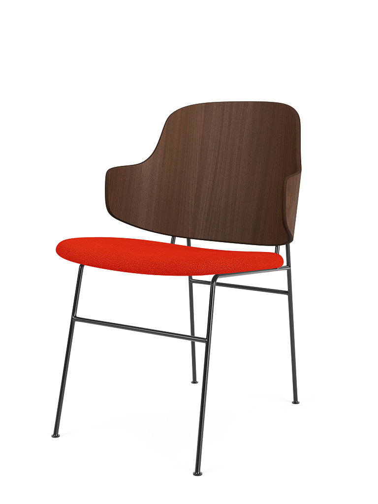 The Penguin Dining Chair with a walnut veneer backrest, bright orange Hallingdal 65 seat, and black steel frame.