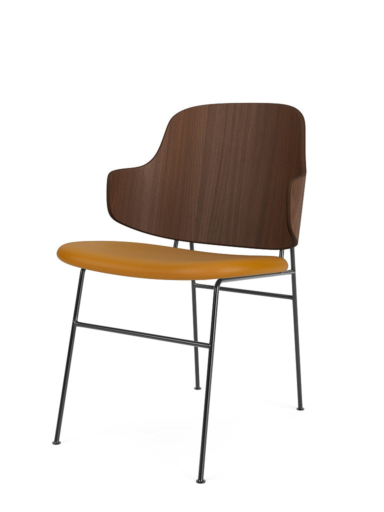 The Penguin Dining Chair with a walnut backrest, mustard yellow Dakar 0250 upholstered seat, and black steel frame.