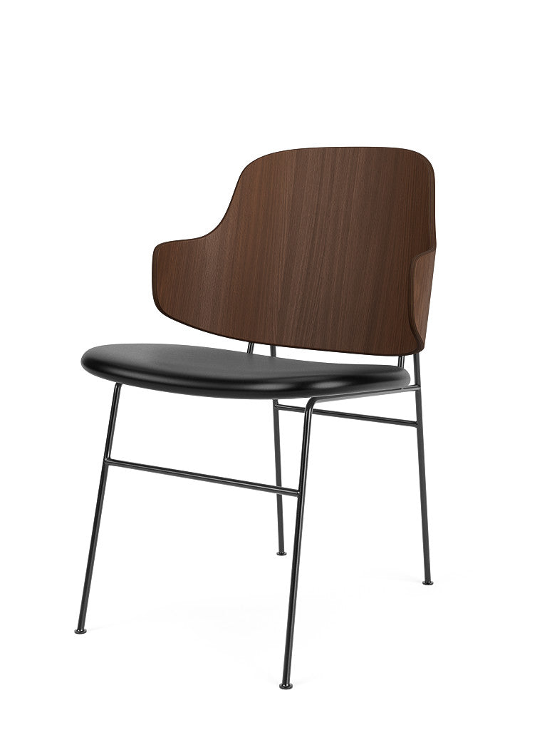 An angled view of the Penguin Dining Chair with its dark walnut veneer back, black leather seat, and slim black steel legs.