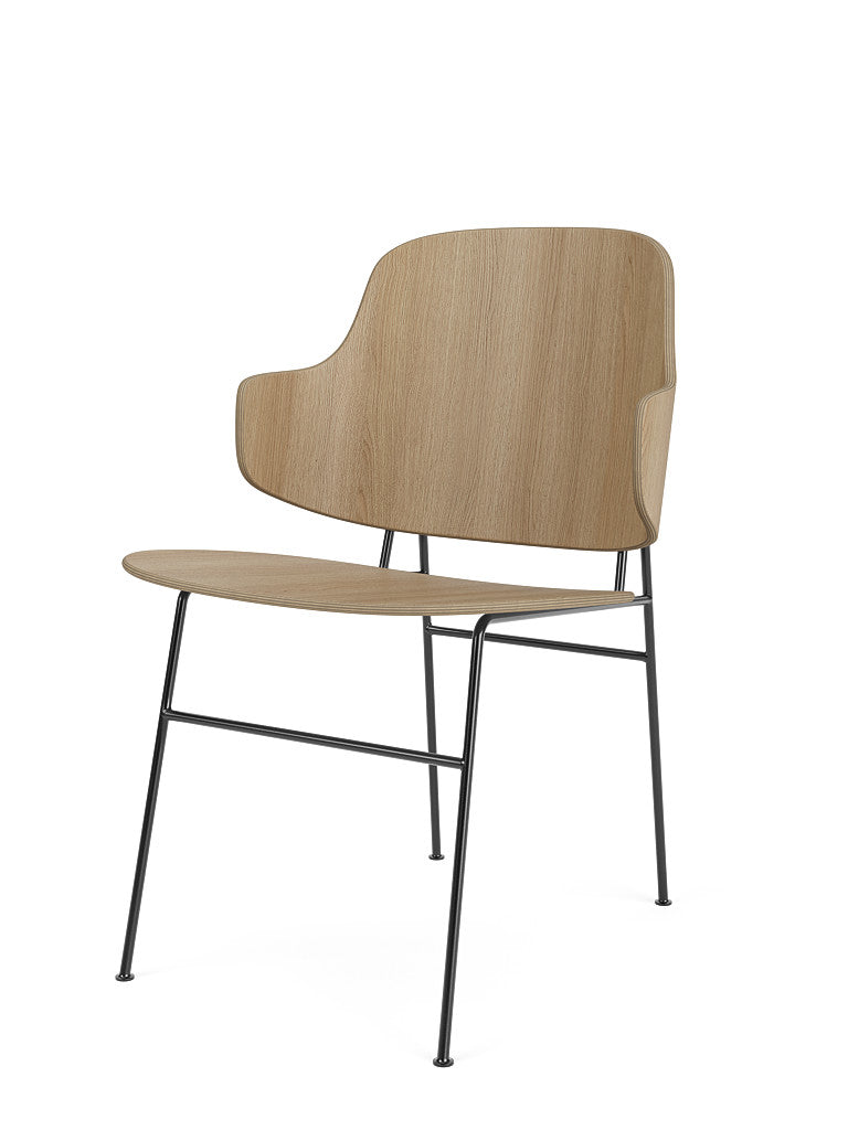 Angled view of the Penguin Dining Chair in natural oak, featuring a curved wooden back and seat on a slim, black metal frame.