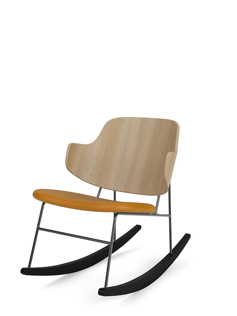 Angled view of The Penguin Rocking Chair with a natural oak backrest, tan leather seat, and a black frame and rockers.