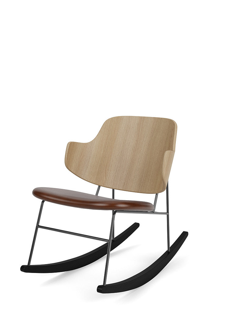 The Penguin Rocking Chair, shown from the side, with a natural oak backrest, a brown leather seat, and a black steel frame.