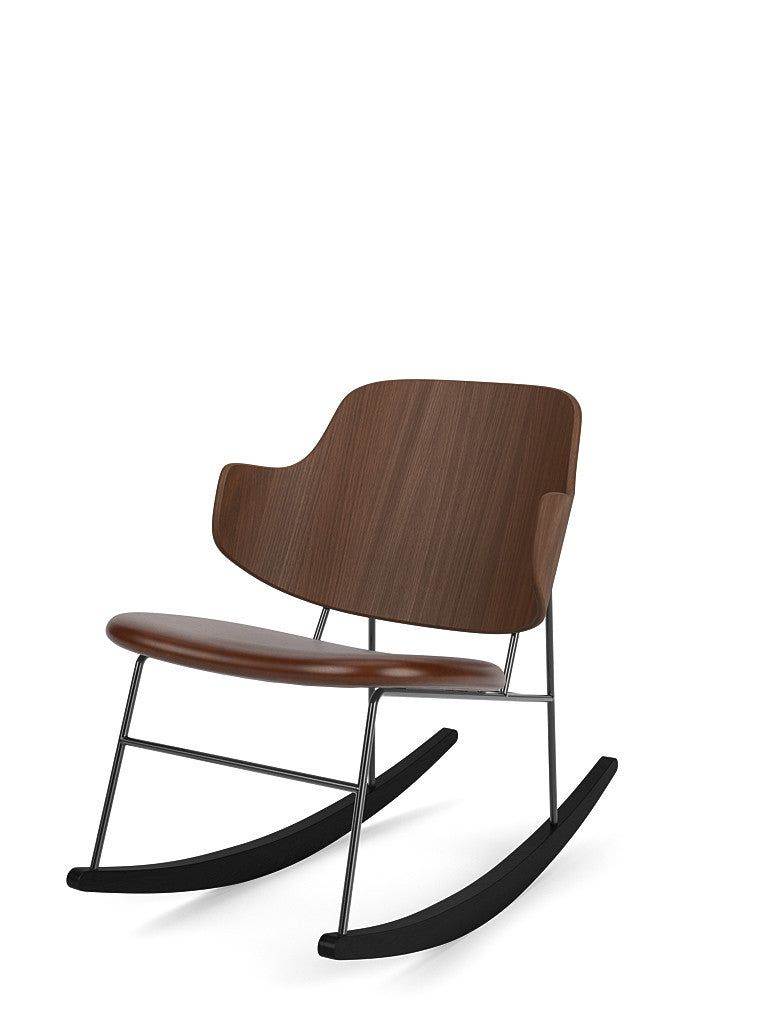 Angled product shot of The Penguin Rocking Chair with a walnut veneer back and brown leather seat on a black steel frame.