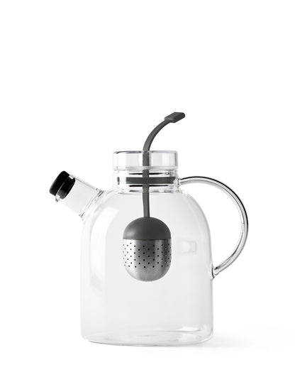 The Audo Kettle Teapot, a minimalist glass teapot with a steel and silicone tea infuser inside, against a white background.