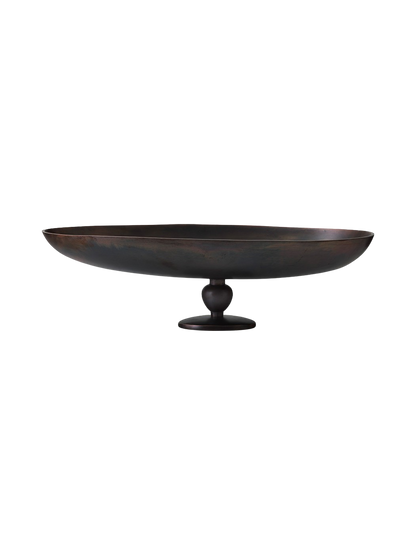 Front view of the Relevé Platter in black wood, showcasing its wide, shallow oval shape atop a short, sculpted pedestal base.