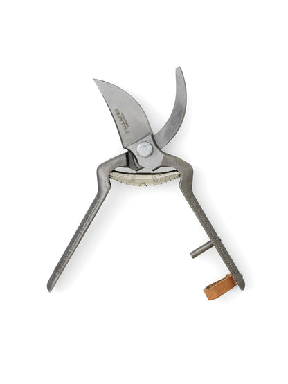 An open pair of Pallares Plant Pruners with textured dark grey handles, steel blades, and a small leather strap.