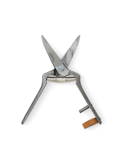 Open Pallares Plant Shears with textured metal handles, serrated blades, and a leather strap lock against a white background.