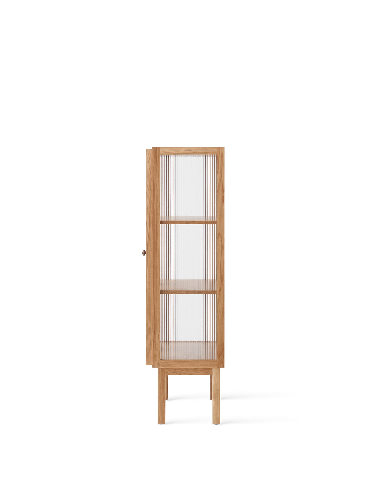 Side view of the tall Curiosity Cabinet in lacquered solid oak, showing its reeded glass door and two interior shelves.