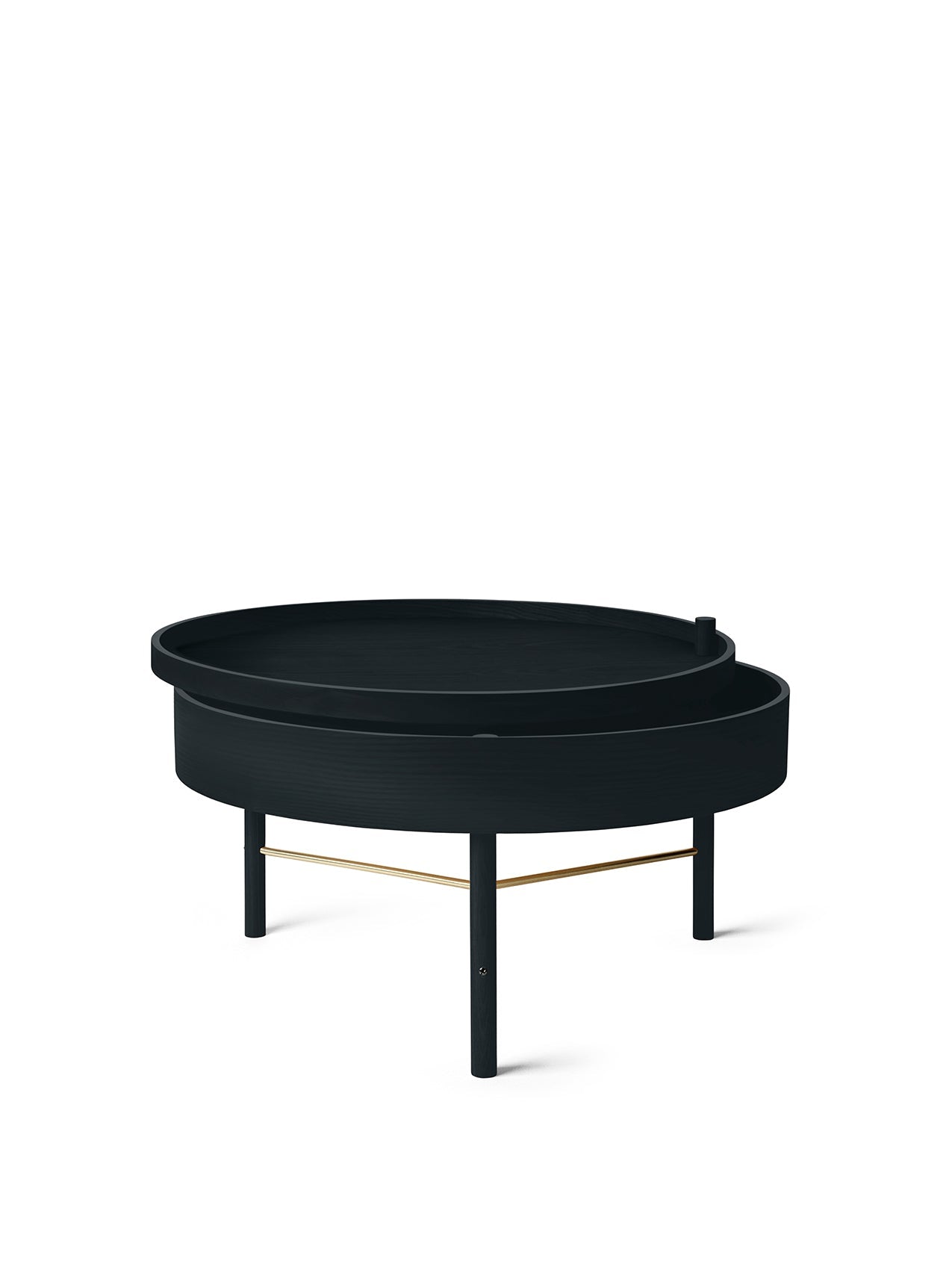 The round, black ash Turning Table, its top pivoted open to reveal storage. It has three legs with a brass accent bar.